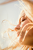 Close up serene woman enjoying wind and sunshine
