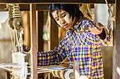 Asian girl weaving fabric, Myanmar