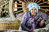 Asian girl selling herbs in market, Myanmar