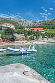 Inflatable boat in lake in remote landscape, Croatia