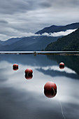 Buoys floating in still remote lake