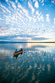 Evening canoe trip in Canadian on Lake Starnberg, Bavaria, Germany