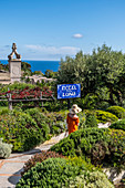 Woman at the entrance to Hotel Luna on Capri, Capri Island, Gulf of Naples, Italy