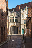 Narrow alleyway leading to Saturday Market Place with Trinity Guildhall and Town Hall, King's Lynn, Norfolk, East Anglia, England, United Kingdom, Europe