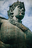 Low angle view of large stone statue of Hindu deity Vishnu.
