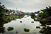 View along small canal with houses built onto the water.