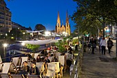 France, Bas-Rhin, Strasbourg, old town listed as World Heritage by UNESCO, cafes boats on the Quai des Bateliers on the banks of the Ill river and Saint-Paul Church in the background