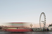 The London Eye, with red London bus on Westminster Bridge at sunset, South Bank, London, England, United Kingdom, Europe