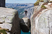 Man on a rock, Kjeragbolten, Kerag chockstone boulder, Lyseboten, Lysefjord, Norway, Scandinavia, Europe