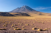 The altiplano at an altitude of over 4000m and the peak of Cerro Miniques at 5910m, Los Flamencos National Reserve, Atacama Desert, Antofagasta Region, Norte Grande, Chile, South America