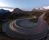 Panoramic of lights of car traces, Bernina Pass, Poschiavo Valley, Engadine, Canton of Graubunden, Switzerland, Europe