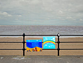 Optimistic paintings tied to railings on a drab British summer day, United Kingdom, Europe