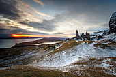 Sunrise breaks through on to a wintery landscape at the Old Man of Storr, Isle of Skye, Inner Hebrides, Scotland, United Kingdom, Europe