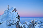 Snow-covered chapel after sunset with sea of fog in the background, from Wendelstein, Mangfall Mountains, Bavarian Alps, Upper Bavaria, Bavaria, Germany