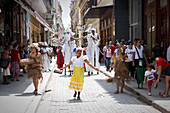 Cuban street parade with music groups and dancers in Havana, Cuba