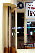 Table, chair and open door in the evening in a simple takeaway in Istanbul, Turkey