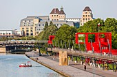 France, Paris, the Parc de la Villette, designed by architect Bernard Tschumi in 1983, the Ourcq canal, red buildings called Folies