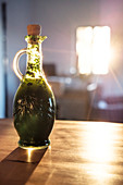 A bottle of wild garlic oil on the kitchen counter in the morning sun, Berg am Starnberger See, Bavaria, Germany.