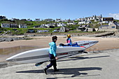 Stand-up paddle boarders in the village of Colliston Pier, Aberdeenshire