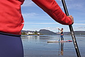 Stand up paddle boarding in the village of Plockton on Loch Carron, Highlands