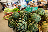 Artichokes and rhubarb in the display of the market hall Les Halles, Redon, Ille-et-Vilaine department, Brittany, France, Europe