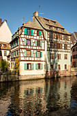 Traditional half-timbered houses on the canal in La Petite France district in sunny autumn, Strasbourg, Alsace-Champagne-Ardenne-Lorraine, France, Europe