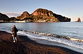 Woman on the beach at Porto Levante on the island of Vulkano, Aeolian Islands, southern Italy