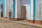 Cubans are walking through the streets of Trinidad, Cuba