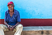 Cubans sit on wayside in Trinidad, Cuba