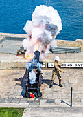 Cannon fires in the Barrakka Gardens in Valletta, Malta