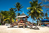 A picturesque lifeguard house stands on the beach between palm trees, Pigeon Point, Tobago, Trinidad and Tobago, Caribbean