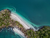 Aerial view of a thin strip of land with white sandy beaches on each side and lush green vegetation surrounded by water in different shades of blue and green, Isla Gamez, Panama, Central America