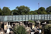 France, Paris, Montmartre Cemetery spanned by the metal bridge of Caulaincourt street