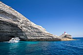 France, Corse du Sud, Bonifacio, under the abrupt cliffs of white limestone the cave marinates of Sdragonato, and the lighthouse of Madonetta