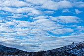 Snowy hills under cloud