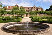 France, Allier, Souvigny, Garden and water basin of the priory and Church of St. Peter and St. Paul