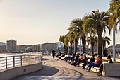 France, Var, Saint-Raphaël, sunbathing on benches of the garden Bonaparte