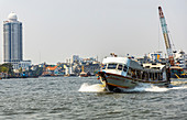 Oncoming traffic boat on the Chao Phraya River, Bangkok, Thailand
