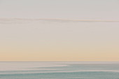 View of calm ocean waters, horizon and sky at dawn, northern Oregon coast