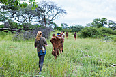 Tourists on a walking trail with members of the San people, bushmen.