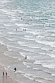View of the waves on the beach at Erquy Bretagne, with bathers.