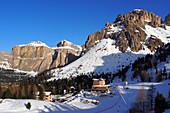 At Belvedere with Sella over Canazei, hotel, rocks, snow, Dolomites, Trentino in winter, Italy