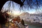 Morning view from Kapuzinerberg, city view, panorama, branches, lights, river, castle, cathedral, reflections, Stadthäuserm Salzburg in winter, Austria