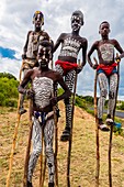Bena tribe boys walking on stilts near Key Afer, Omo Valley, Ethiopia.