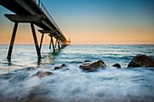 badalona bridge at sunset with the sea in motion