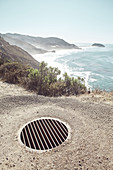 Drain grate on Highway 1 near Big Sur State Park, California, USA.