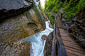View of the steep walls and the wooden path in the Wimbachklamm, Berchtesgadener Land, Bavaria, Germany