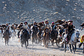 The opening ceremony of the Golden Eagle Festival with a parade of the eagle hunters on the festival grounds near the city of Ulgii (Ölgii) in the Bayan-Ulgii Province in western Mongolia.