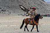 The eagle calling competition (after the eagle is released from a mountain top it to land on the hand of the hunter) at the Golden Eagle Festival near the city of Ulgii (Ölgii) in the Bayan-Ulgii Province in western Mongolia.