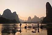 Cormorant Fisherman Throwing Fish Net on River Li\nGuilin Region\nGuangxi, China\nLA008312\n